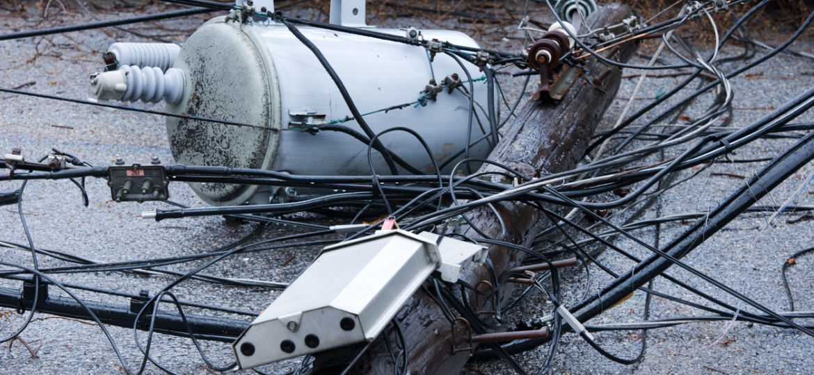 damaged power lines and transformer on the ground after hurricane