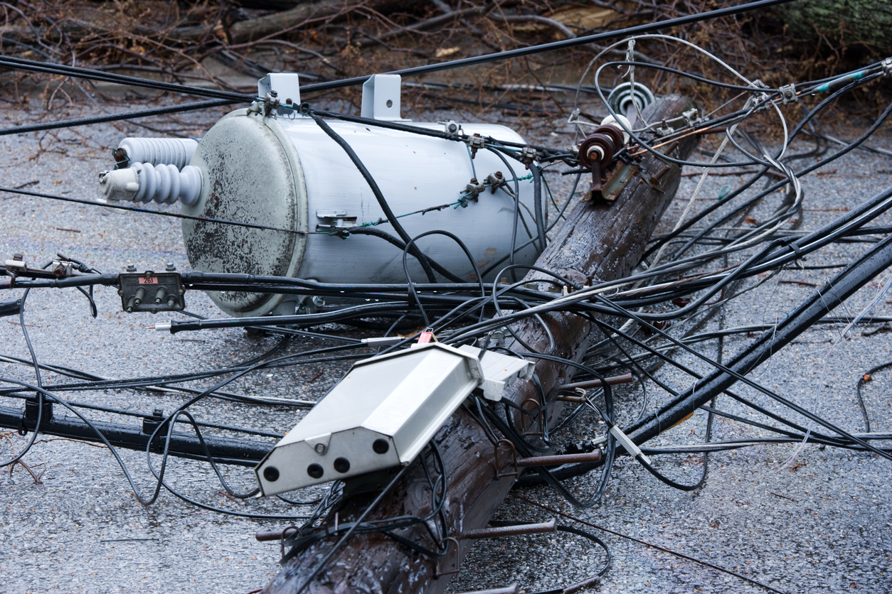 damaged power lines and transformer on the ground after hurricane