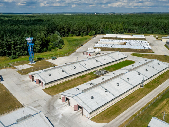 An aerial photo of two warehouse buildings in a farm.