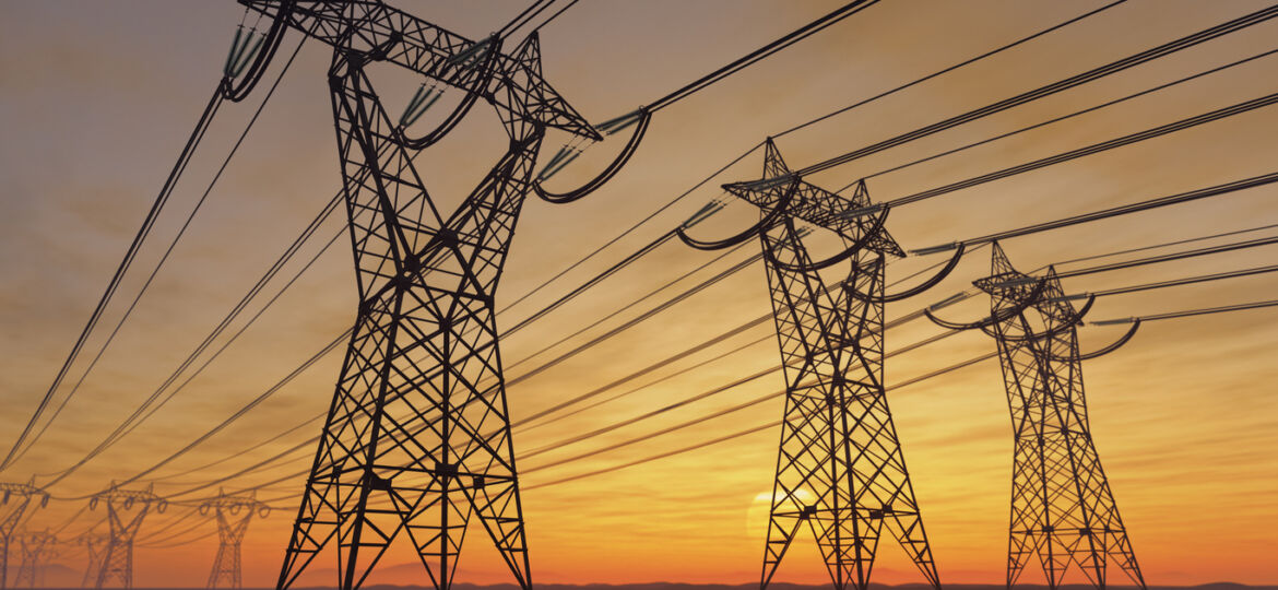 A photo of power poles during a sunset