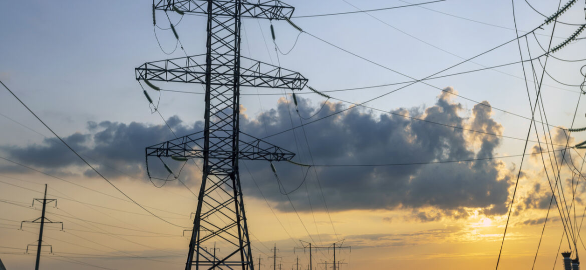 Wires and pylons of a high voltage line at sunset