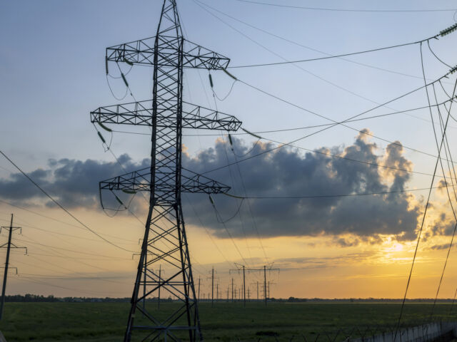 Wires and pylons of a high voltage line at sunset